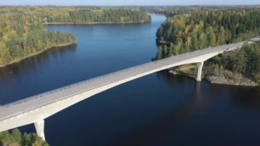 Finlandiya 'daki Saimaa Gölü üzerindeki uzun ve yüksek köprü havadan görülebilir. Kamera yukarı doğru hareket ediyor. Adalar sonbahar ormanlarıyla kaplıdır. Rus-Fin sınırına yakın. Jeoloji video 44k.