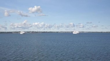 Tallinn.Estonya-28 Ağustos 2020: Gökyüzündeki bulutlarla Estonya 'nın Tallinn limanından deniz manzarası. Uzaktan iki beyaz yolcu gemisi görülebilir. Kamera uzaklaşıyor..