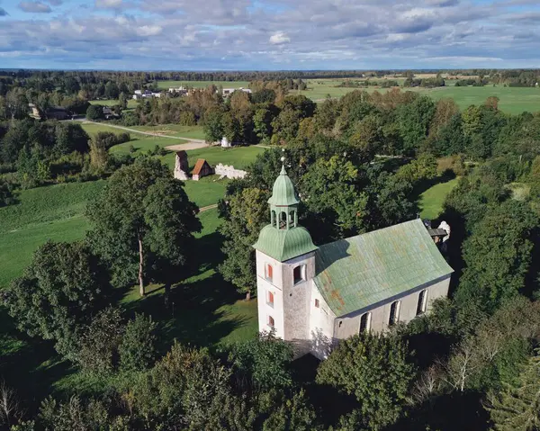 Karksi, Estonia September 25, 2025: Karksi church in Estonia, an ancient architecture building, standing among green trees and fields, offering a sense of history and serenity