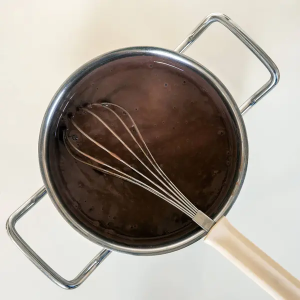 How to cook a chocolate pudding. Cooking pot with chocolate pudding. High quality photo