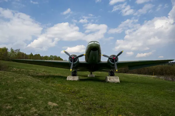 Soviet military aircraft Lisunov Li-2 on a meadow in the forest.