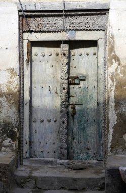 Metal çivili entrika oyulmuş ahşap kapı.