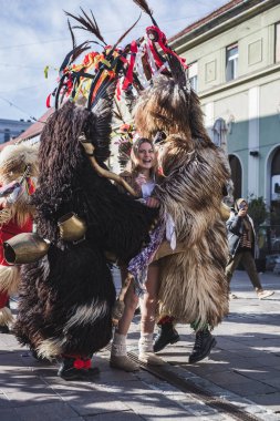 Kurtlarla çevrili bir kadın. Slovenya 'daki karnaval maskeli bir kuren. İlkbaharda giyilecek geleneksel bir kostüm. Kur 'an bizim mekanımızda.