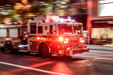 New York, NY USA Fire truck with emergency lights on the street of Manhattan clipart