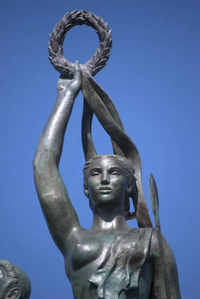 bronze statue of the woman of a greek god