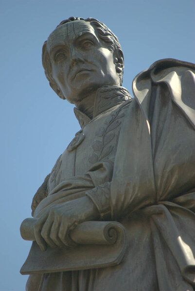 a statue of Simon Bolivar holding a book