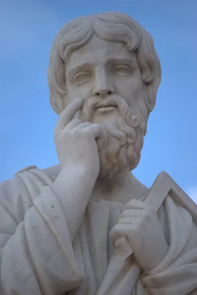 a statue of a man with a beard and a book