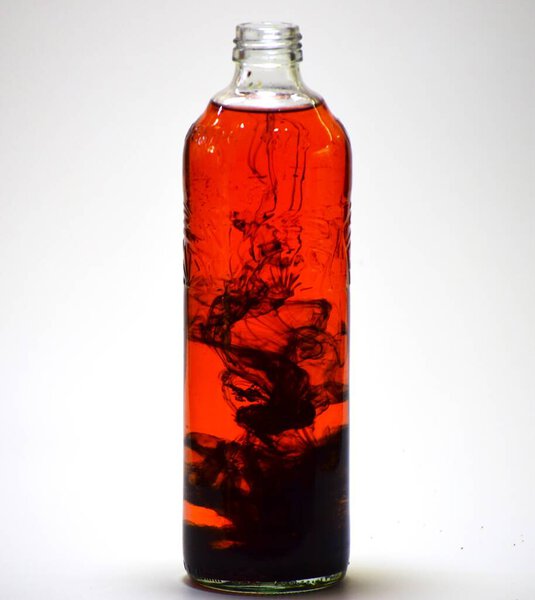 glass bottle with a black background