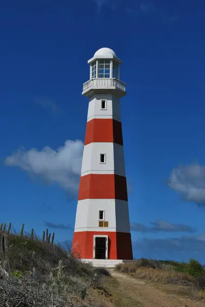 stock image a vertical shot of the lighthouse in a cloudy sky