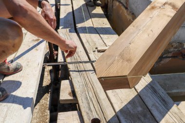 Tahta tahtada çalışan bir adam, arka planda çalışan bir adam.