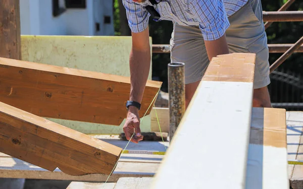 worker working with wooden frame in construction site