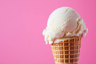 Close-up of a vanilla ice cream cone on a pink background, highlighting the creamy texture and refreshing appeal of this classic summer treat. AI Generated clipart