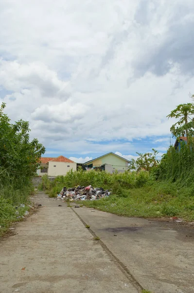 Bir sürü çöpü olan toprak bir yol.