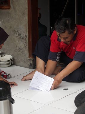 Bandung, Endonezya - 11 Şubat 2024: Endonezya cumhurbaşkanlığı seçimleri için seçim görevlileri halka celp kağıdı dağıttı