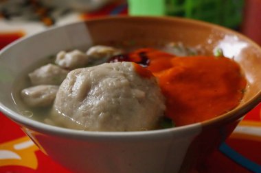 Dev Endonezya köftesi çorbası, baharatlı sambal soslu sıcak servis edilir. Zengin tatları ve rahatlatıcı çorbası olan popüler yerel sokak yemekleri.