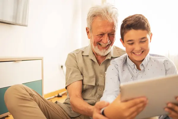 Cheerful Grandfather Grandson Casual Clothes Watching Video Digital Tablet Home — Stock Photo, Image