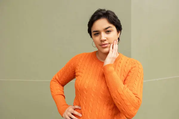 Muotokuva Nuori Latino Nainen Oranssi Pusero Seisoo Käsi Kasvoilla Vastaan — kuvapankkivalokuva
