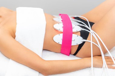 Laser lipo equipment. Cosmetic fat reduce treatment. Woman in medicine salon. Anti cellulite procedure. High quality photo