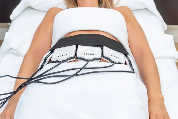 Woman receiving slimming lipo laser therapy in spa. High quality photo