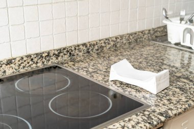 Folded tetra pack container on the stove top ready to be recycled. . High quality photo