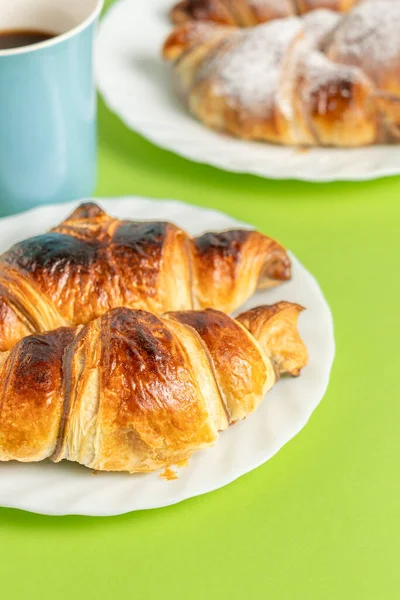 Perfect breakfast with chocolate croissants and coffee on a light green table. High quality photo