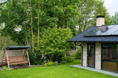 Evin çatısındaki güneş paneli. Sürdürülebilir kaynaklar ve modern eko yeşil ev kavramları. Yüksek kalite fotoğraf