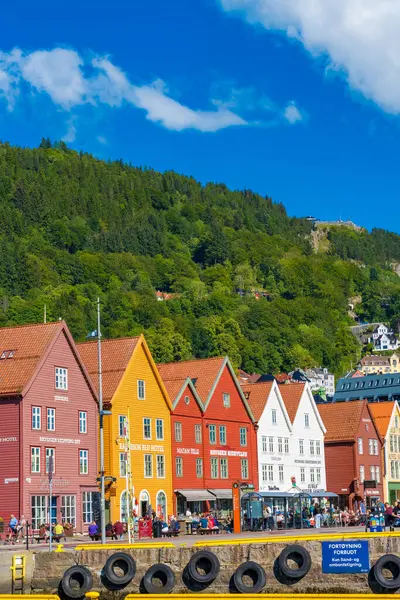 stock image Bergen, Norway - July 9, 2024: Summer day in Bergen, Norway, showcases Bryggen - traditional red wooden houses set. Colourful historical landmark in the city center