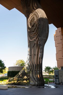 Prag, Çek Cumhuriyeti - 21 Eylül 2024: Çek ressam David Cerny 'nin Karlin' deki modern bir binayı destekleyen paslanmaz çelik heykel bacağının yakın çekimi. Mimariyle harmanlanmış halk sanatı.