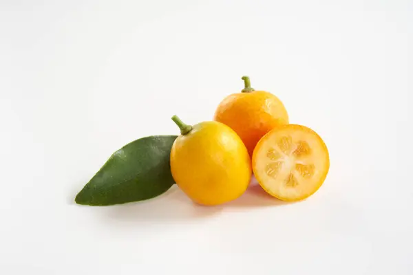 beyaz arkaplanda kumkuat meyveleri