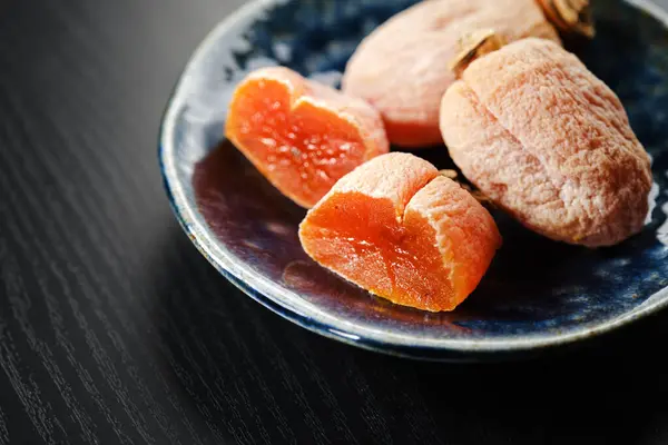 Ahşap zeminde kurutulmuş Japon hurması.