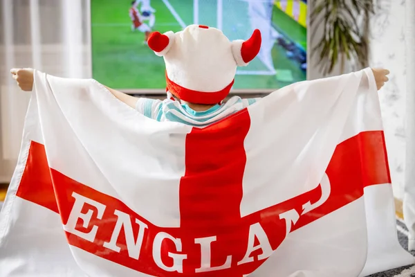 stock image A boy with England flag watching soccer game on TV and supporting his national football team