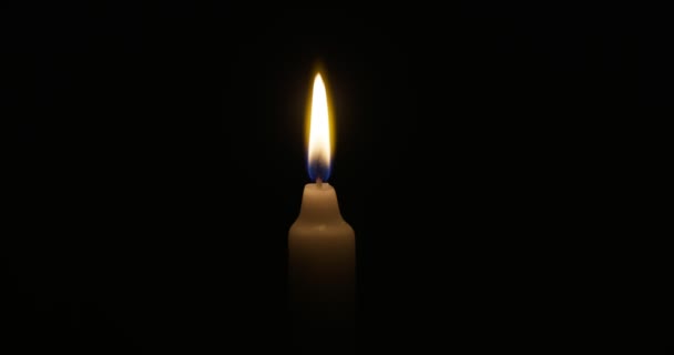 Candle Burns Soft Yellow Flame Isolated Candle Burning Dark Background — Stock videók