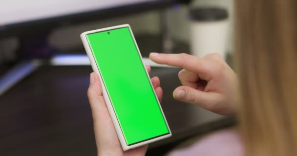 Woman Using Smartphone Vertical Mode Green Mock Screen Doing Swiping — Stock video
