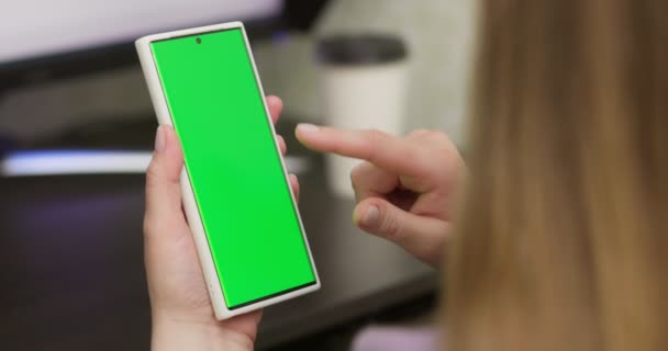 Woman Using Smartphone Vertical Mode Green Mock Screen Doing Swiping — Stock Video