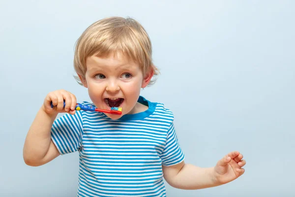 Little Blonde Boy Brushing Teeth Toothbrush Blue Background Dental Hygiene — Foto Stock