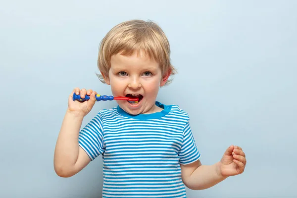Little Blonde Boy Brushing Teeth Toothbrush Blue Background Dental Hygiene — 图库照片
