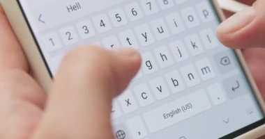 Woman typing a text message on her smartphone. Female hands typing or chatting. High quality 4k footage
