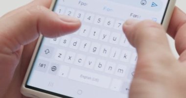 Woman typing a text message on her smartphone. Female hands typing or chatting. High quality 4k footage