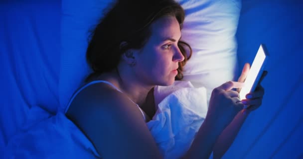 Woman Lies Bed Night Uses Smartphone Female Using Mobile Phone — Stockvideo