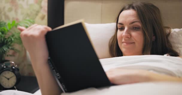 Ung Kvinna Läser Intressant Bok När Hon Ligger Sängen Kvinna — Stockvideo