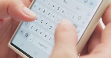 Woman typing a text message on her smartphone. Female hands typing or chatting. High quality 4k footage