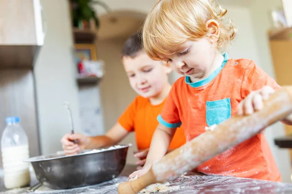 stock image Fun family, cute kids making dough for cookies in the kitchen.