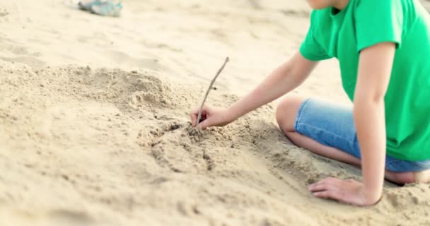 Barnpojke Leker Med Sand Havsstranden Varmt Solsken Sommaren Barnet Drar — Stockvideo