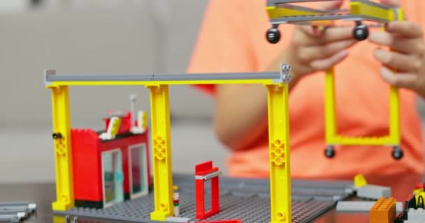 Barnpojken Leker Och Bygger Med Färgglada Plasttegelstenar Vid Bordet Tidig — Stockvideo