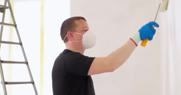Man Painting Wall White Paint Using Roller Brush Renovation House — Stock Video