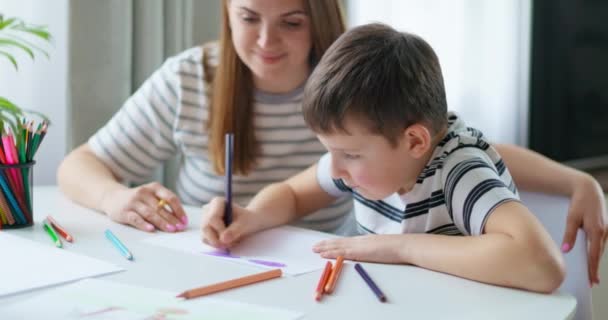 母亲和儿子专注于在家里用铅笔着色 高质量的4K镜头 — 图库视频影像