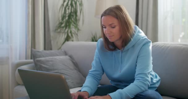 Focused Woman Comfortably Working Her Laptop Potentially Telecommuting Well Lit — Stock Video