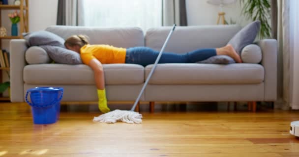 Person Lying Sofa Mop Robotic Vacuum Cleaner Hardwood Floor Casual — Stock Video