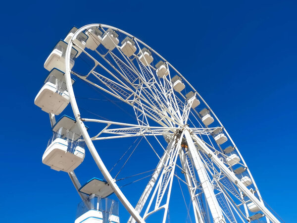 Huge white ferris wheel with blue sky