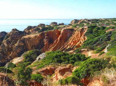 hiking from beach praia de dona ana in Lagos, Portuhgal, to ponta de Piedade on new wooden broadwalks clipart